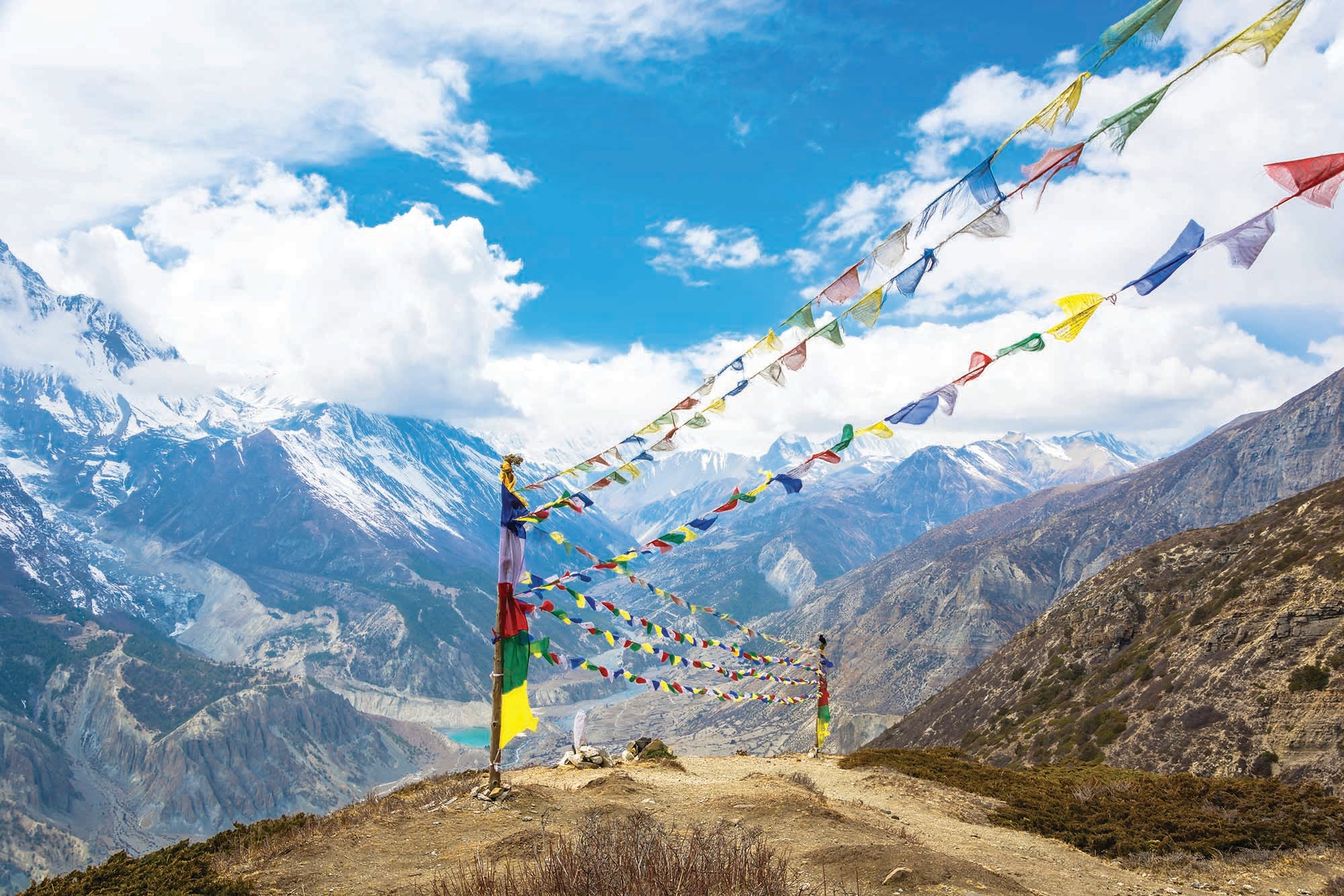 Rows of coloured flags above snowy peaks of the Himalayan mountains, Nepal.