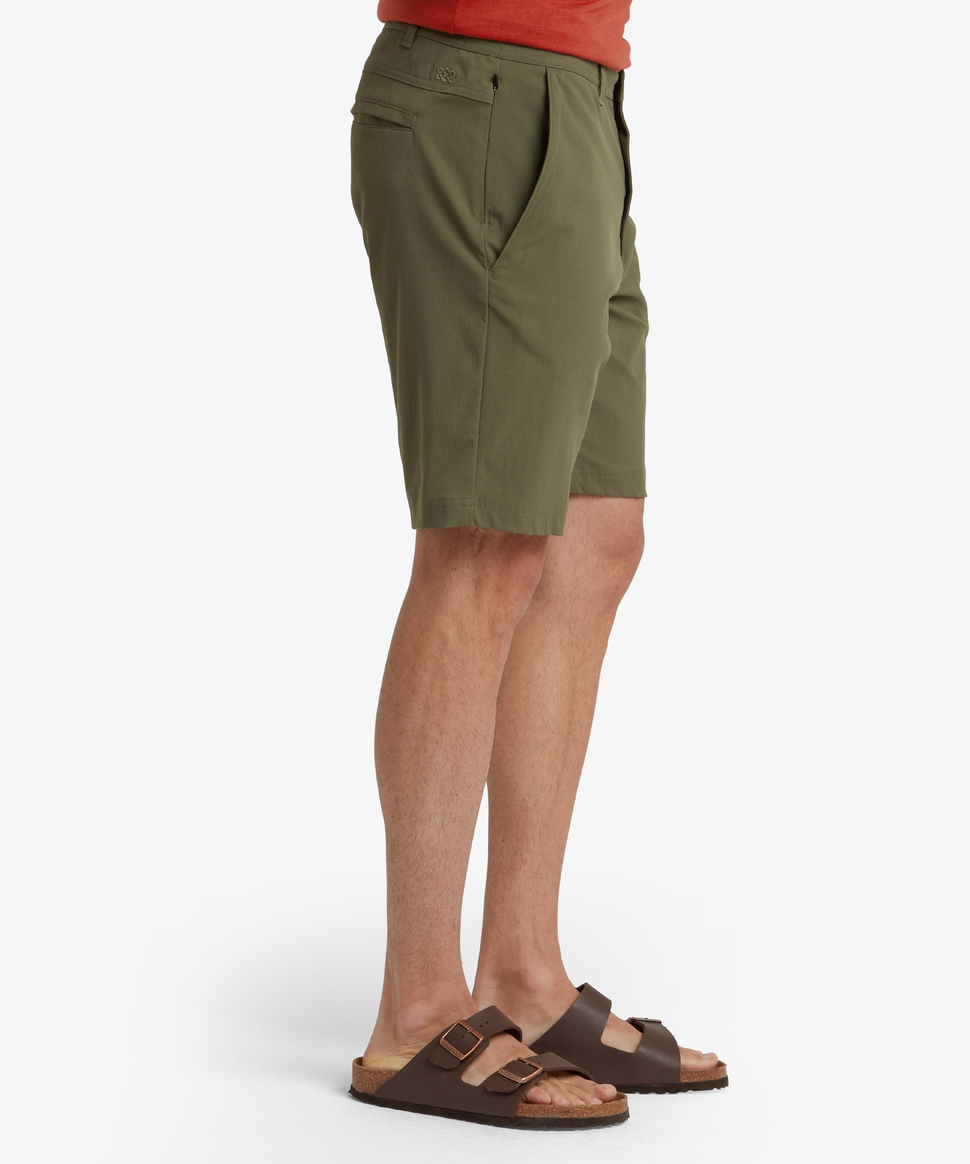 A back view displaying the Sherpa Adventure Gear Bara Shorts in Greens’ back pocket design, featuring two welt pockets with one buttoned closure. The tailoring of the shorts is evident in the clean lines and structured fit, enhancing the overall appearance.