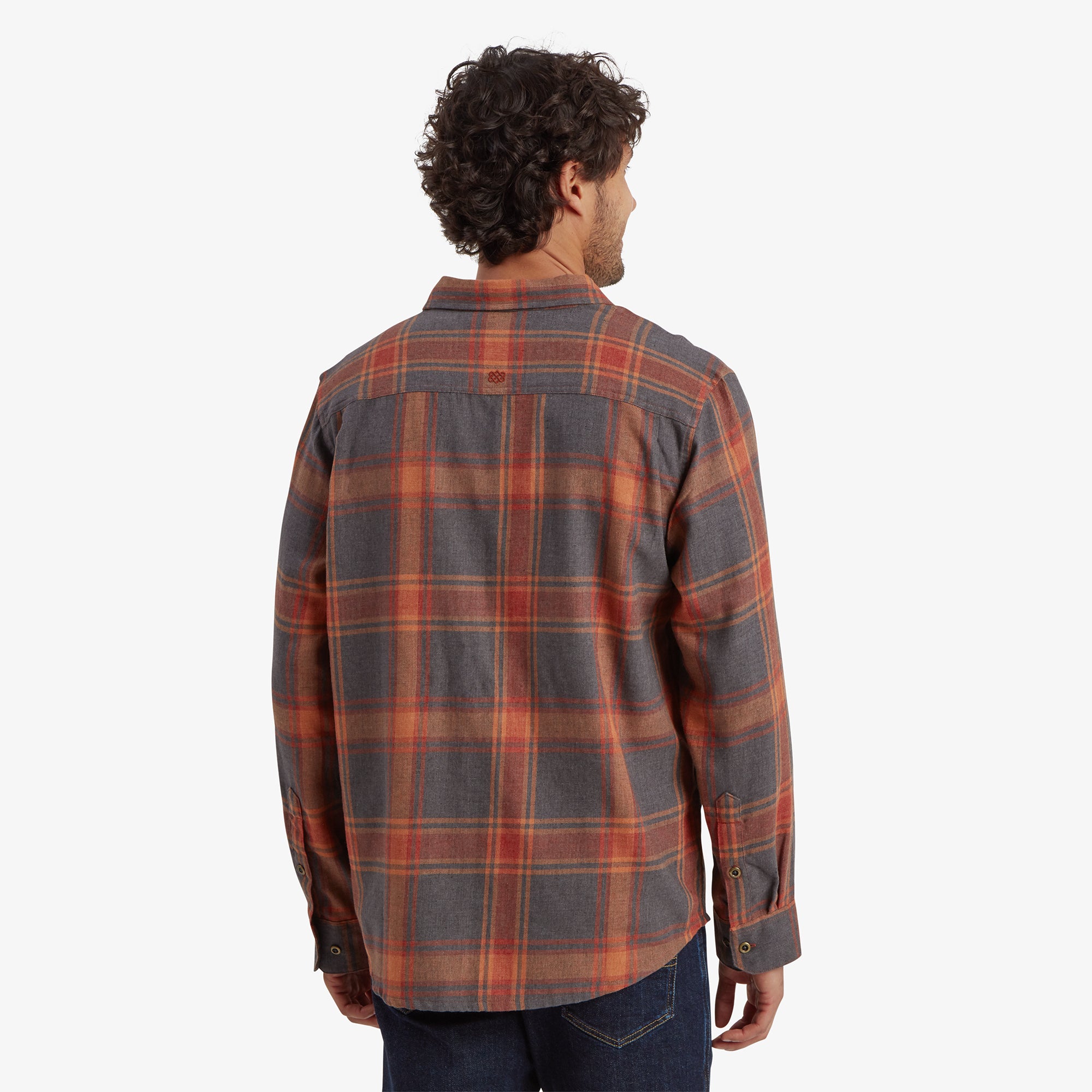 A back view of the Sherpa Adventure Gear Batsa Long Sleeve Shirt in Red, showing the full checkered pattern and yoke detail on the shoulders. The model is facing away, giving a complete view of the shirt's back panel.