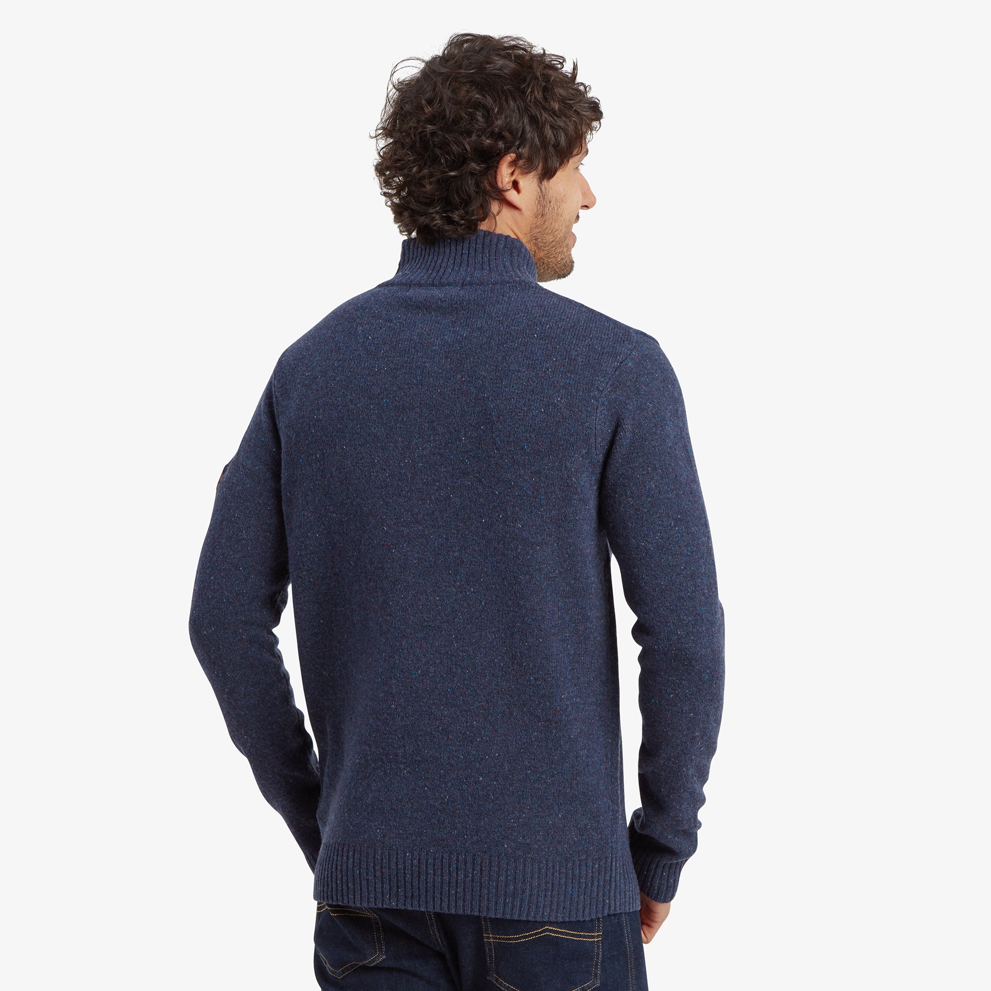 The back of the Sherpa Adventure Gear Kangtega Quarter Zip Sweater in Blue is shown, showcasing its seamless and clean design with ribbed detailing on the hem and collar, creating a polished look.