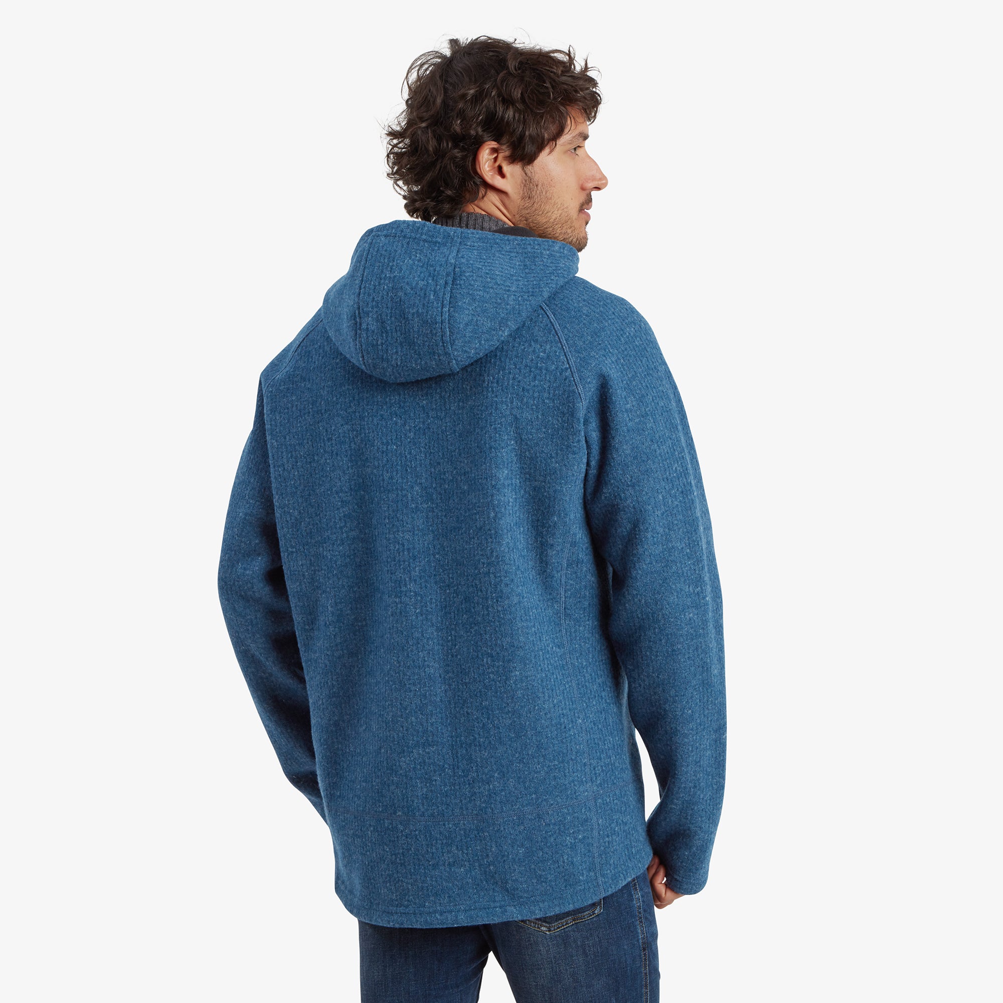 A back view of the Sherpa Adventure Gear Namgyal Hoodie in Blue showing its well-fitted design and attached hood. The texture of the fabric and the seamless construction of the hoodie are evident from this perspective.