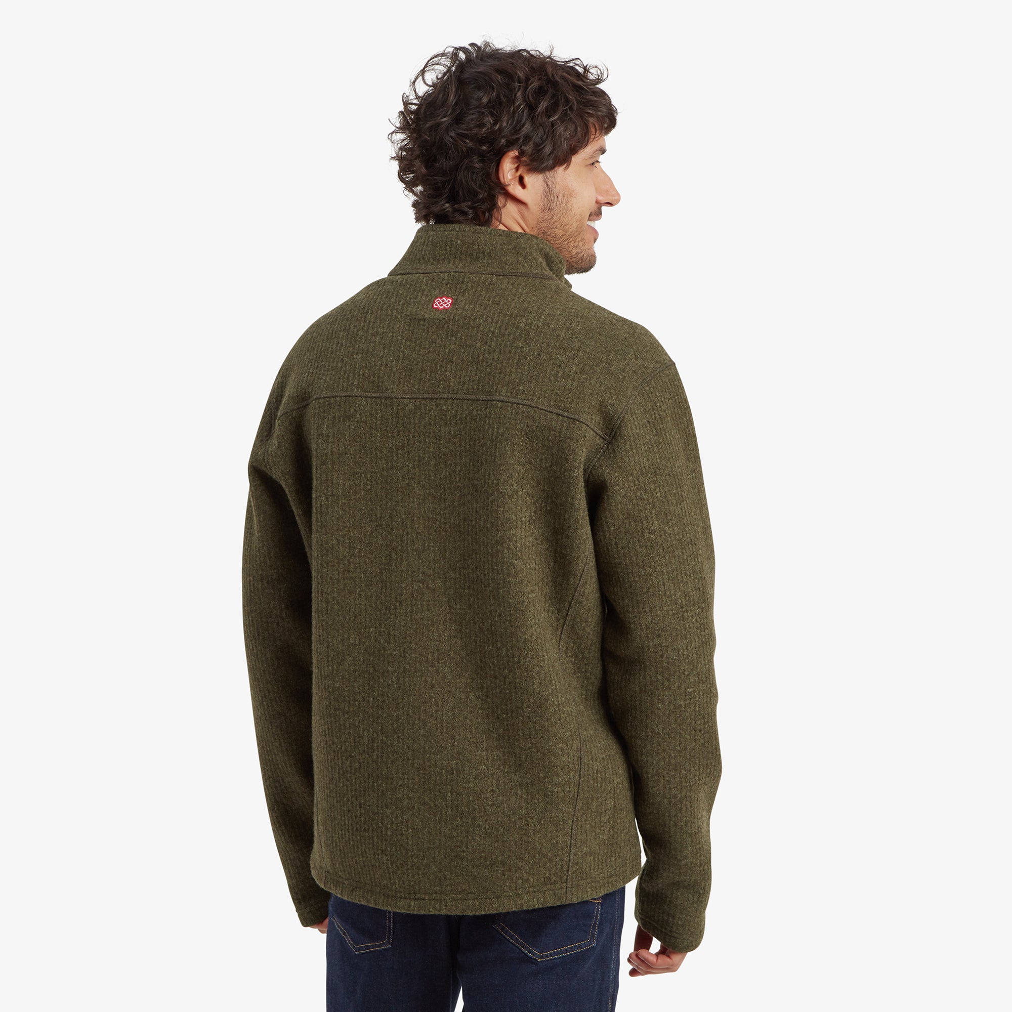 The back view of the Sherpa Adventure Gear Namgyal Jacket in Brown, revealing a yoke detail across the shoulders and a small Sherpa Adventure Gear logo near the neck. The jacket’s hemline sits comfortably at the hips, providing a tailored yet relaxed fit.