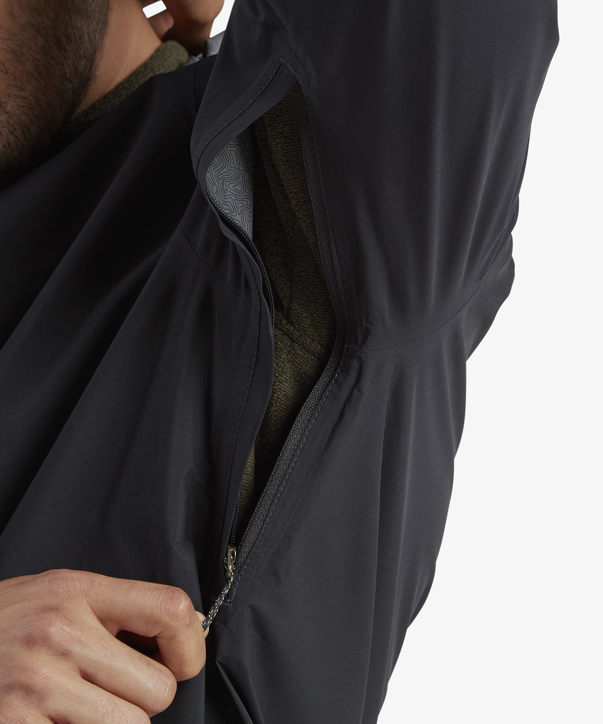 A detailed image showing the Sherpa Adventure Gear Nima 2.5-Layer Jacket in Black’s cuff adjustment system, with Velcro straps allowing a secure and customizable fit at the wrists.