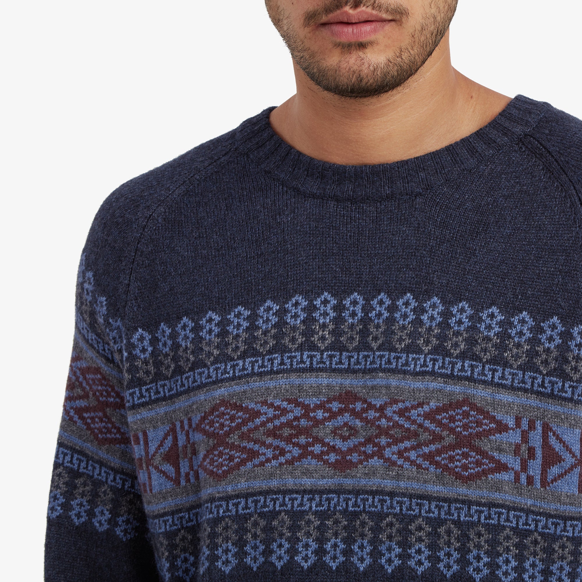 A close-up of the Sherpa Adventure Gear Sajit Eco Crew in Blue's geometric pattern across the chest, highlighting the intricate knit design and color details.