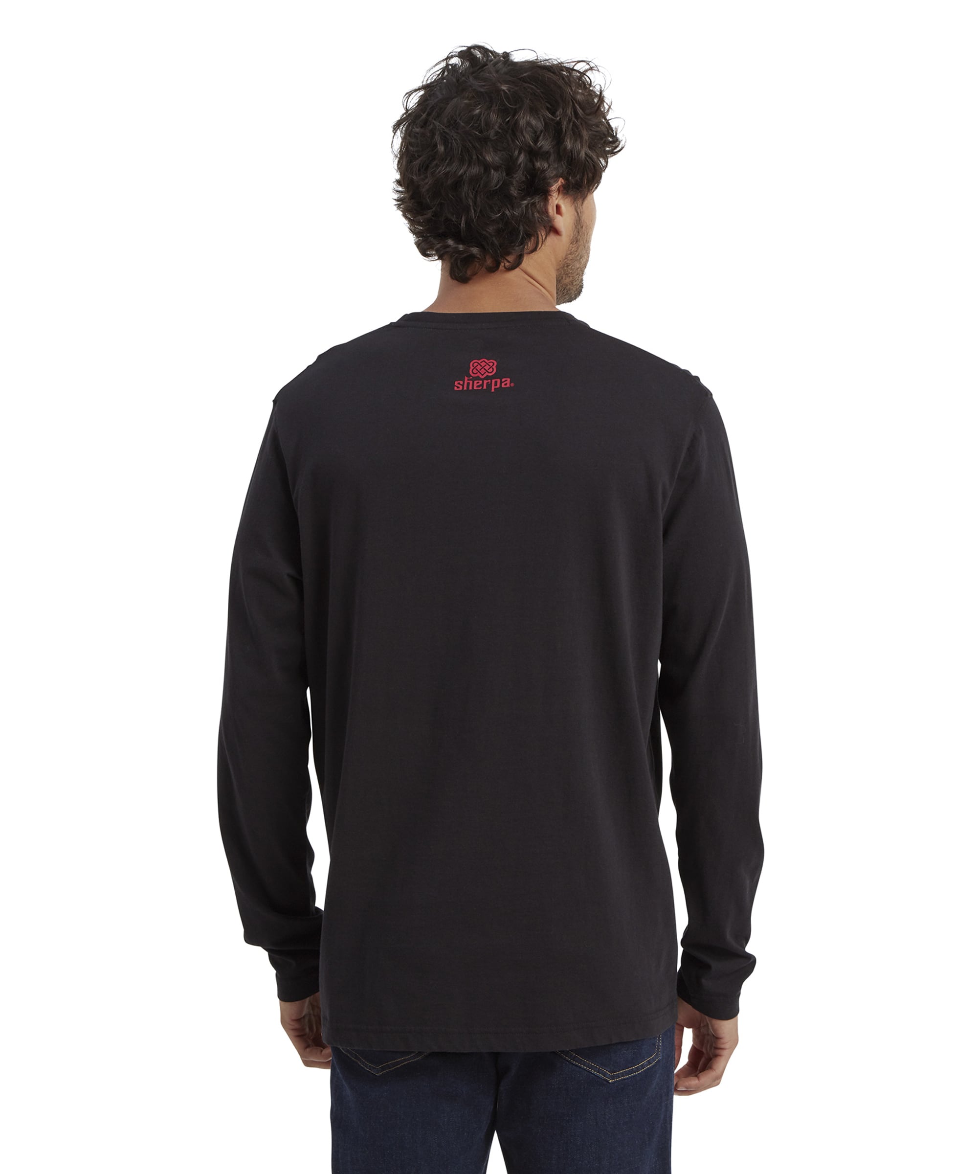 Back view of the Sherpa Adventure Gear Tarcho Long Sleeve T-Shirt in Black, showcasing a plain black fabric with the Sherpa logo and a small decorative symbol in red printed near the neckline. The simplicity of the back complements the intricate design on the front.