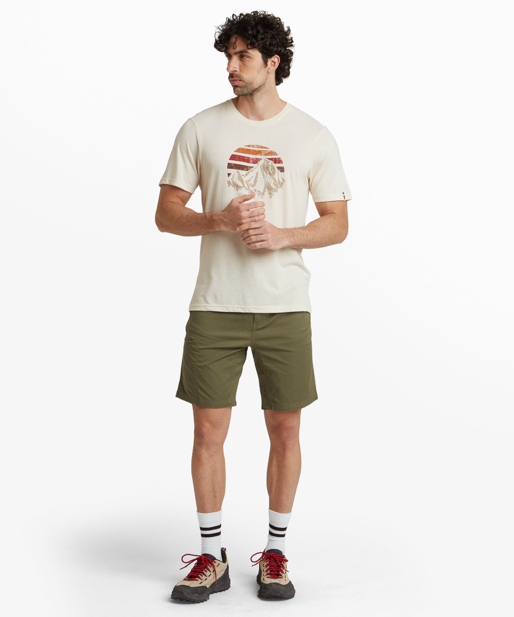 A side view highlighting the clean lines and practical design of theSherpa Adventure Gear Tenjing Shorts in Green. The side pocket with a zipper is visible, offering a functional detail. The shorts fall above the knee and showcase a slim yet comfortable fit.