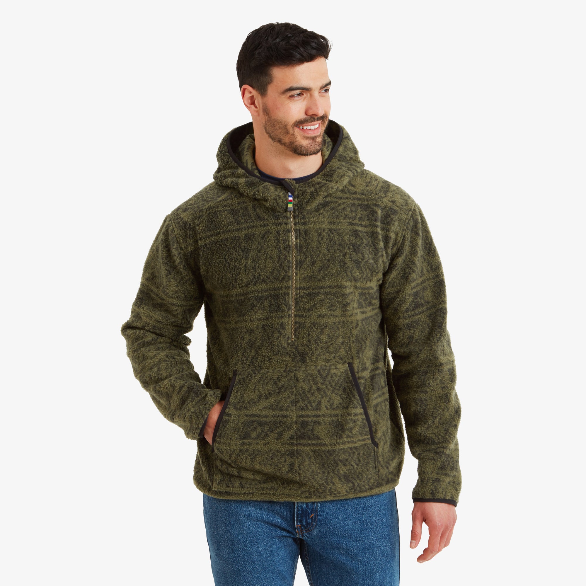 A male model is wearing a Sherpa Adventure Gear Uddesya Eco Quarter Zip Hoodie in Green. The hood is up, showcasing its snug fit around the head. He has his left hand casually in the hoodie’s side pocket, emphasising the functional pocket design. The textured fleece material is clearly visible, showcasing its cozy and sustainable nature.