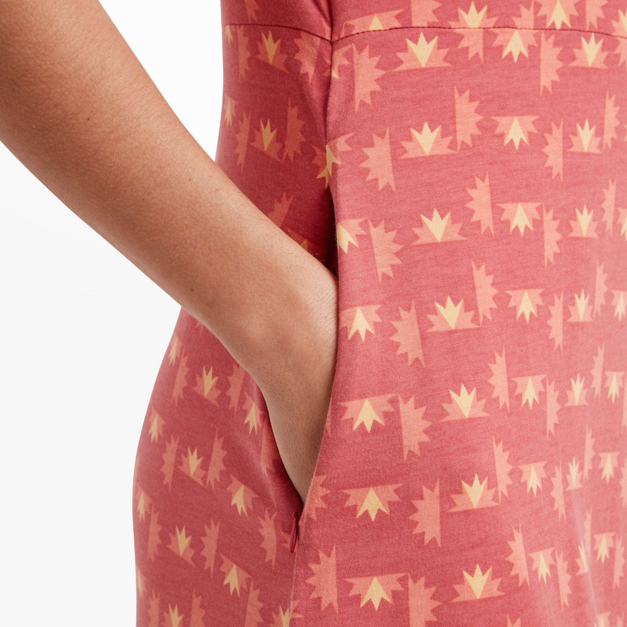 A close-up of the Sherpa Adventure Gear Padma Wrap Dress in Red's pocket detail, showing the functionality of the design. The pocket blends seamlessly with the geometric print, enhancing the practicality without compromising style.