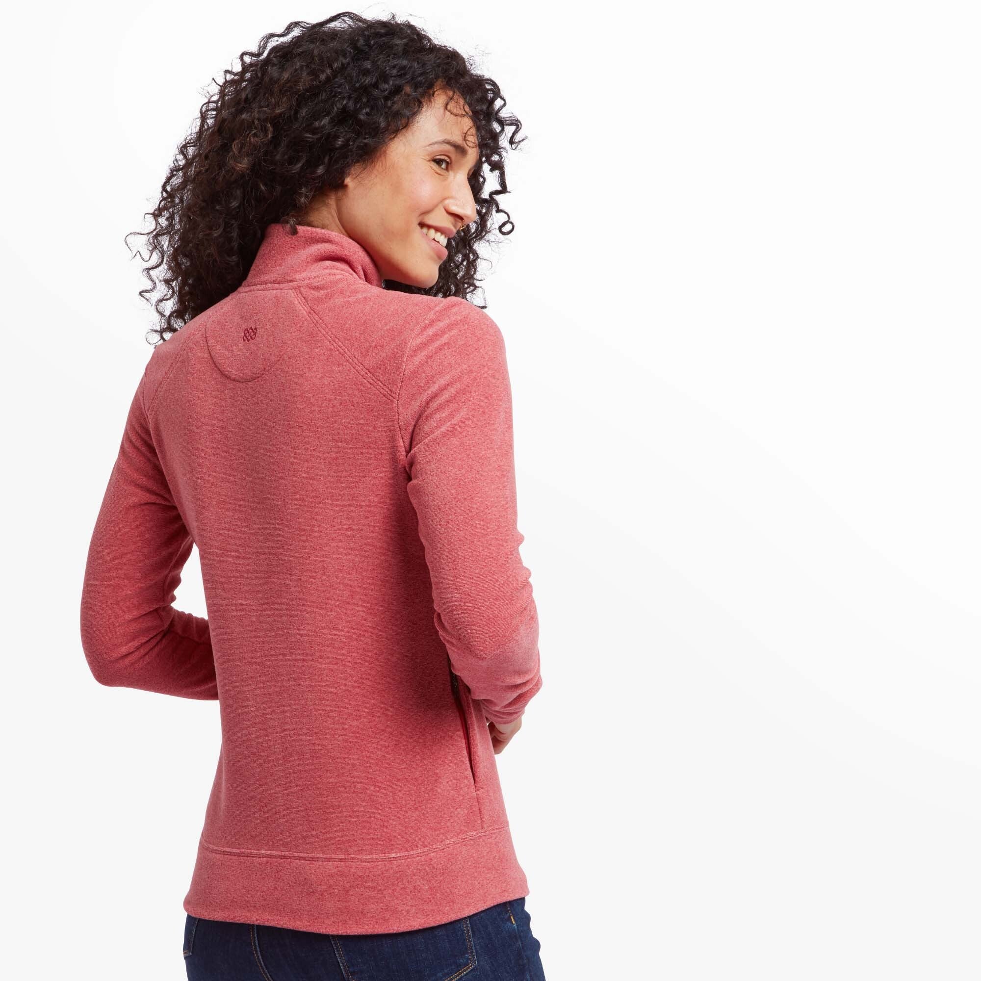 Back view of a woman wearing a Sherpa Adventure Gear Rolpa Eco Jacket in Red. The high collar and tailored fit are visible. The Sherpa logo is subtly embroidered near the neckline.