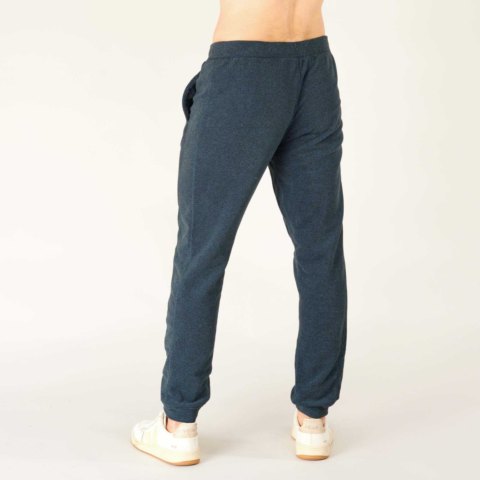 Rear side view of the Sherpa Adventure Gear Rolpa Jogger in Blue, showing how they taper from the hip to the ankle and the clean, streamlined fit.