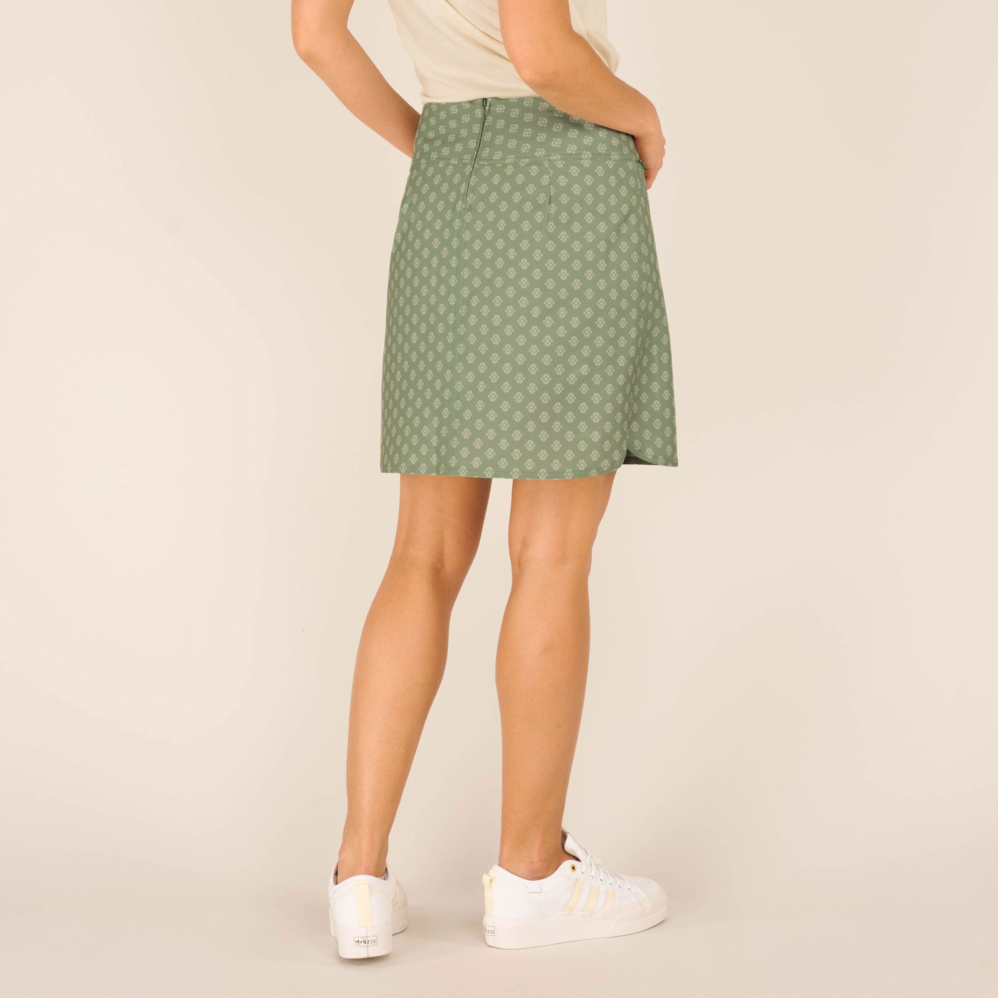 closer look at the back of the Sherpa Adventure Gear Sajilo Adventure Skort in Green, emphasising the subtle print and clean lines, paired with the casual outfit.