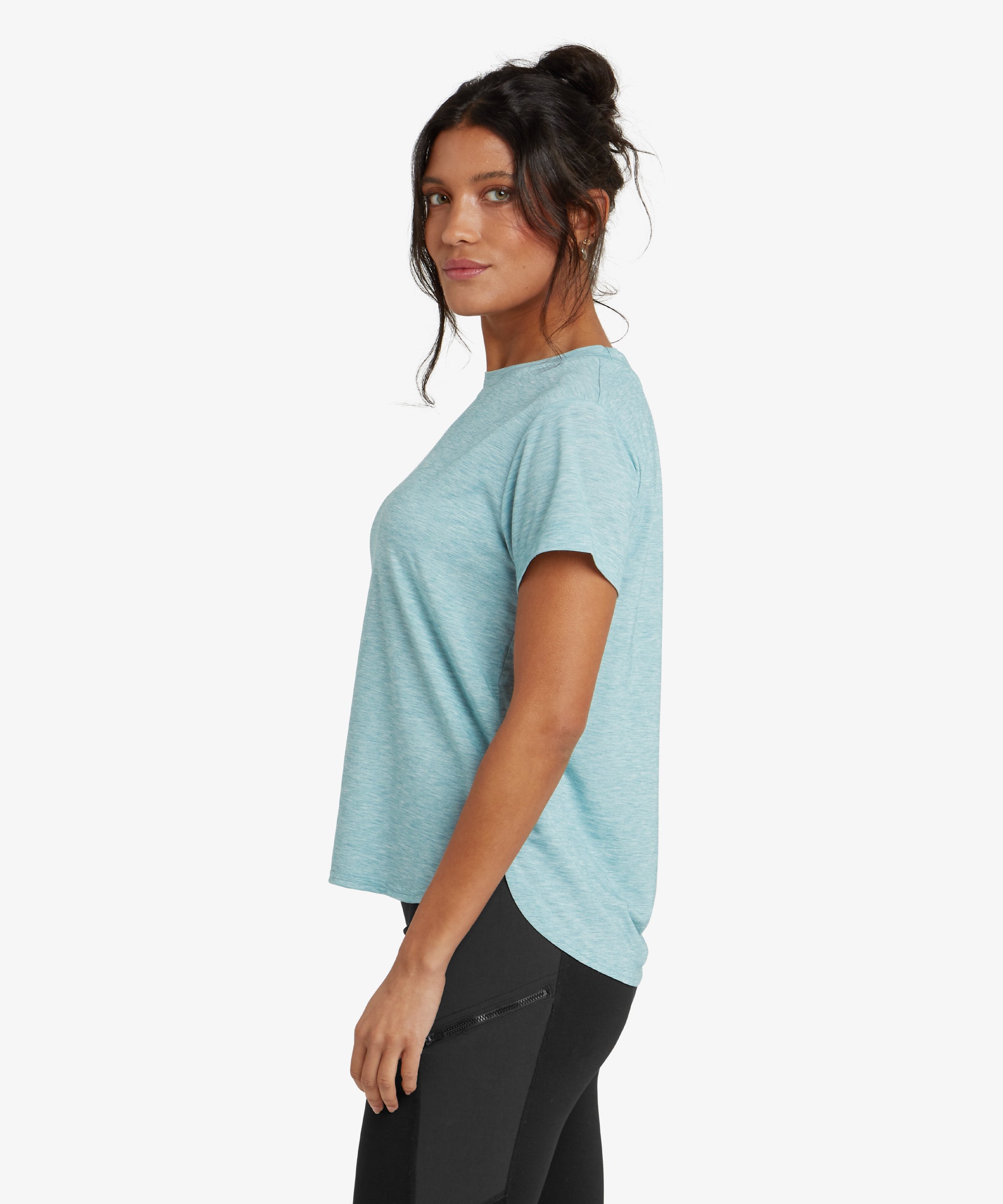 A full back view of the Sherpa Adventure Gear Asha Crew in Blue reveals a simple and clean design without visible logos or patterns. The curved hem and slightly elongated back provide added coverage, ideal for layering or pairing with leggings or activewear bottoms.