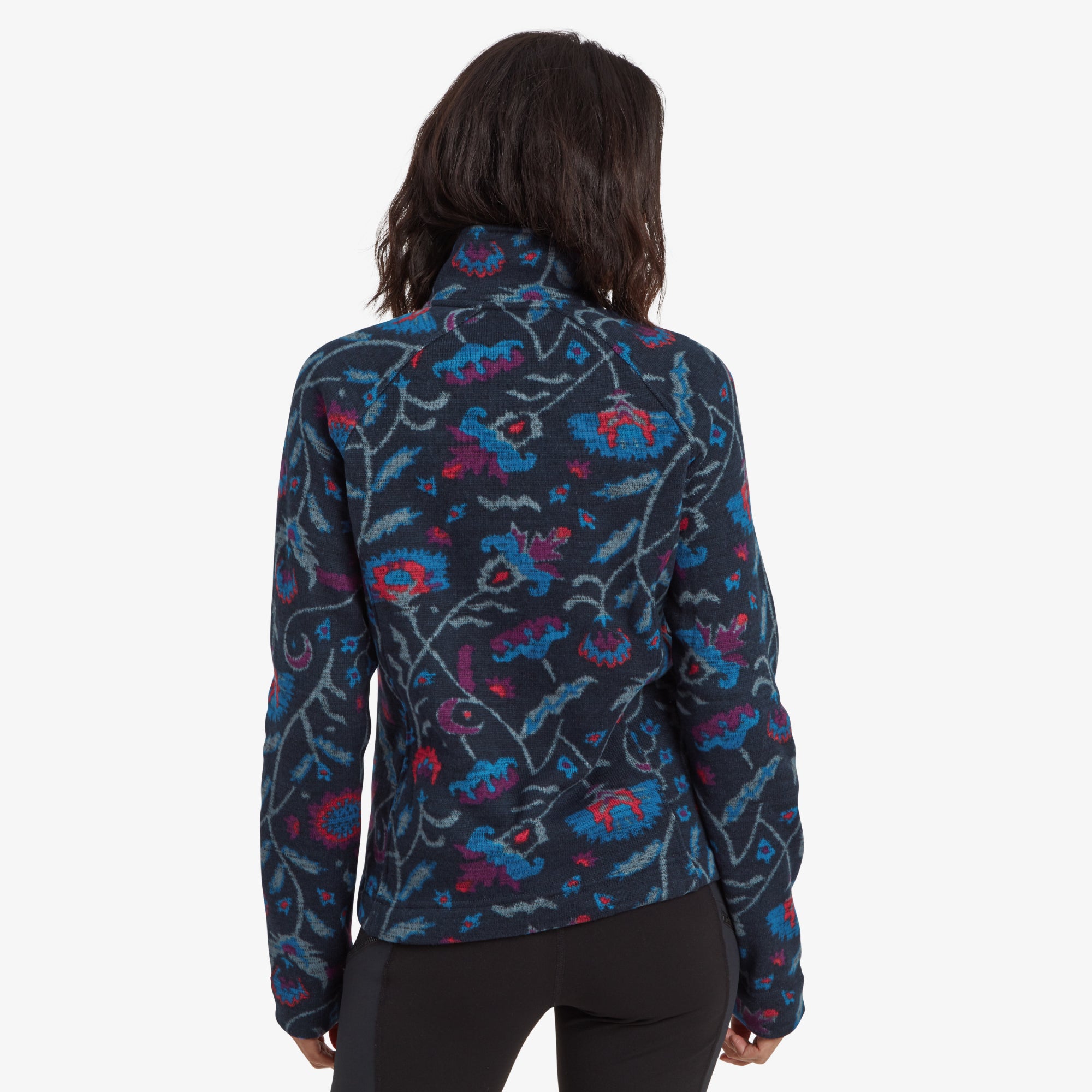 A clear view of the back of the Sherpa Adventure Gear Bhutan Full Zip Jacket in Blue, showcasing the seamless integration of the floral design across the entire piece. The high collar provides an added sense of warmth and elegance.