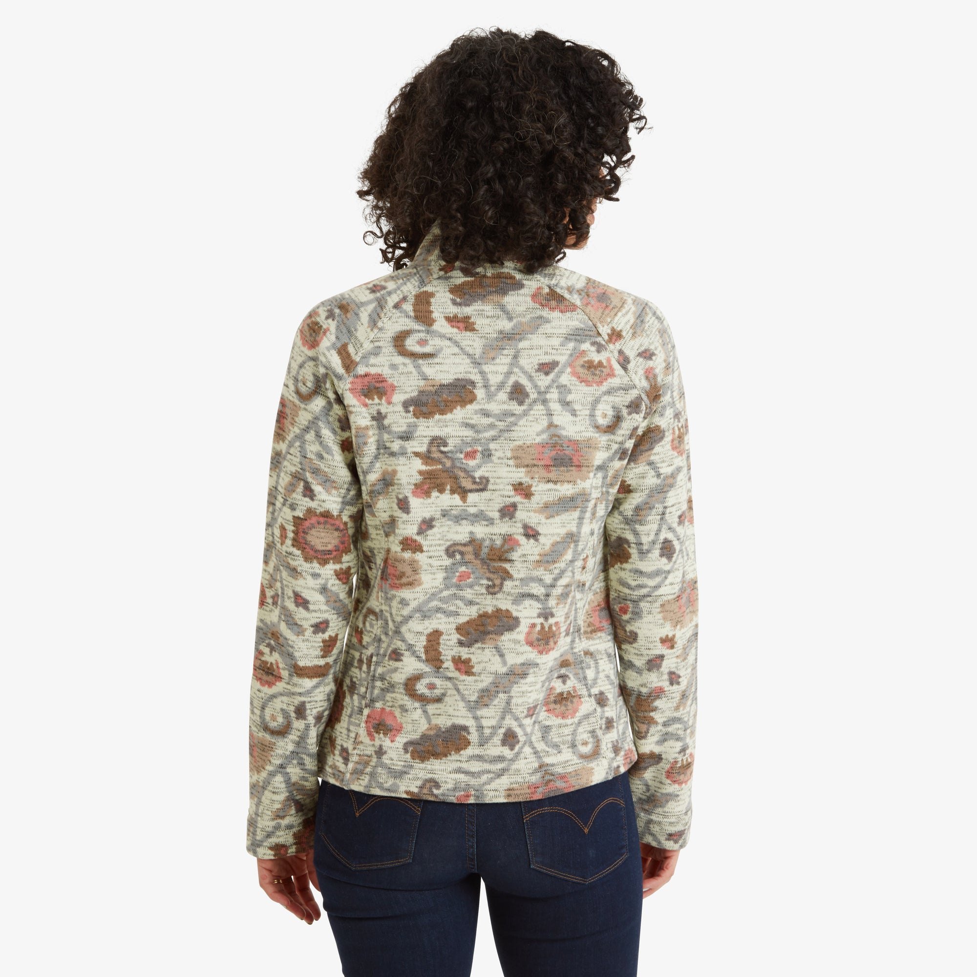 A back-facing image displaying the rear design of the Sherpa Adventure Gear Bhutan Full Zip Jacket in Light Brown, including its tapered fit and continuous pattern across the back. The high collar and clean seams are visible, emphasising the craftsmanship.