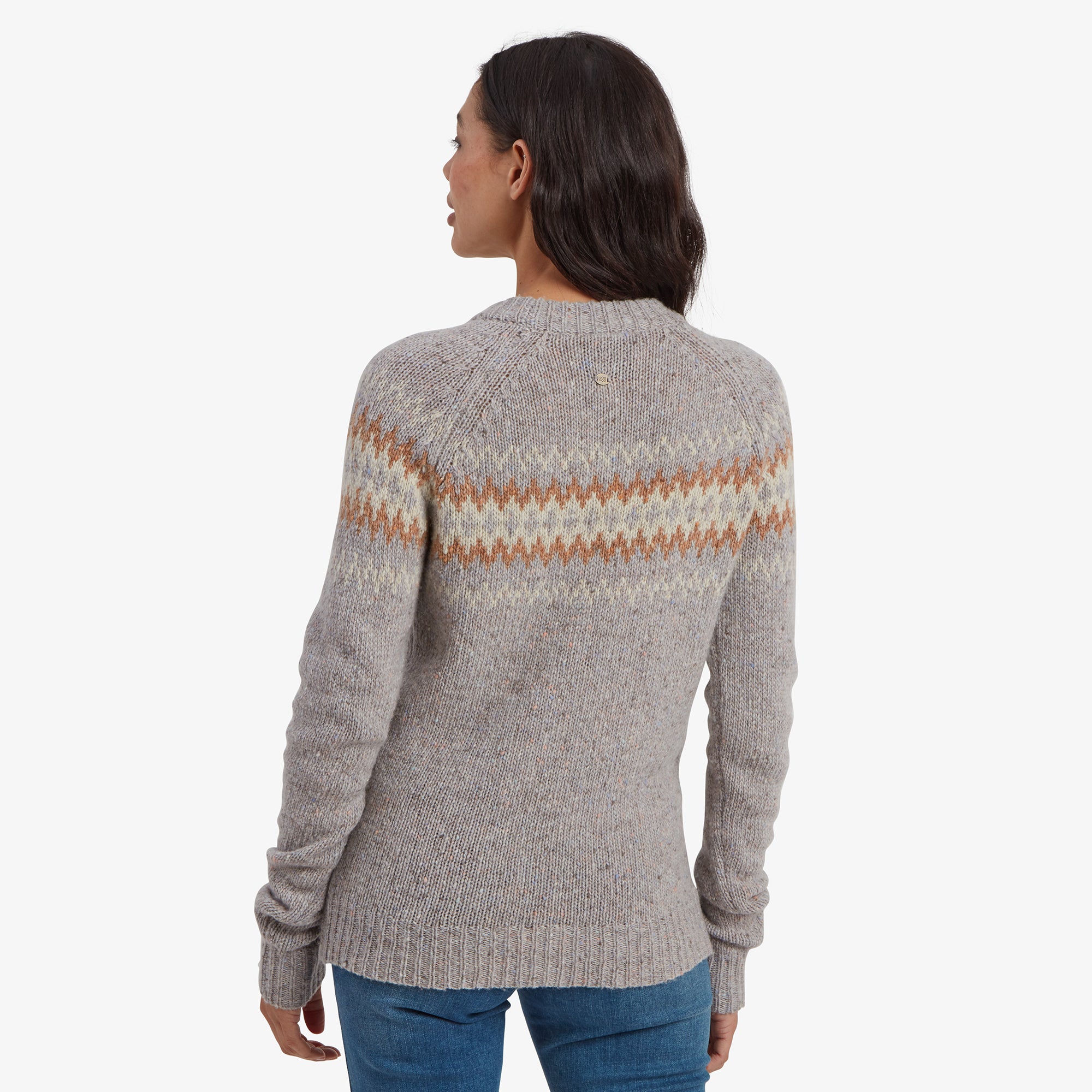 A rear view of theSherpa Adventure Gear Dumji Crew Sweater in Grey emphasises its design continuity. The zigzag pattern wraps across the shoulders, while the back panel features a simple, speckled knit texture. The ribbed neckline and hem ensure a snug and comfortable fit.