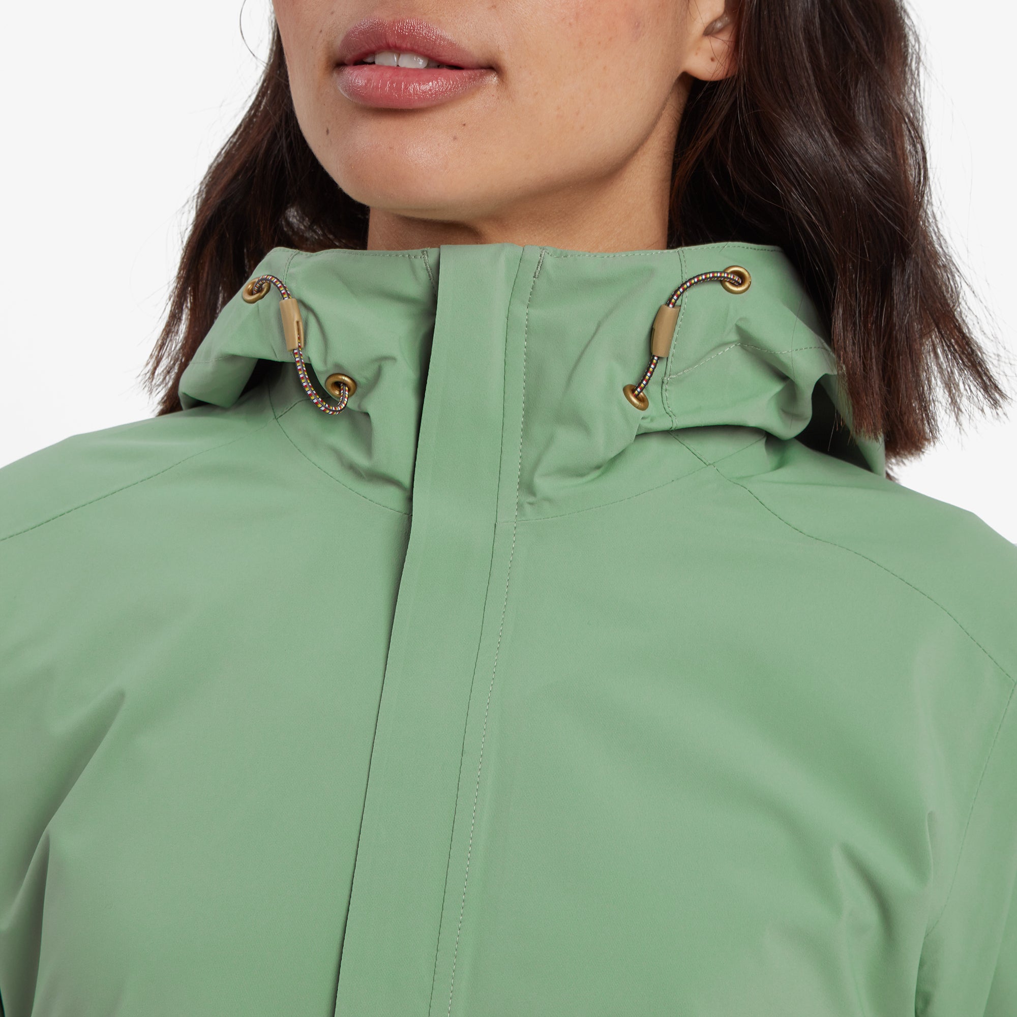 A zoomed-in shot of the Sherpa Adventure Gear Nima 2.5-Layer Jacket in Green's high collar and hood drawstring hardware, highlighting the craftsmanship and texture.