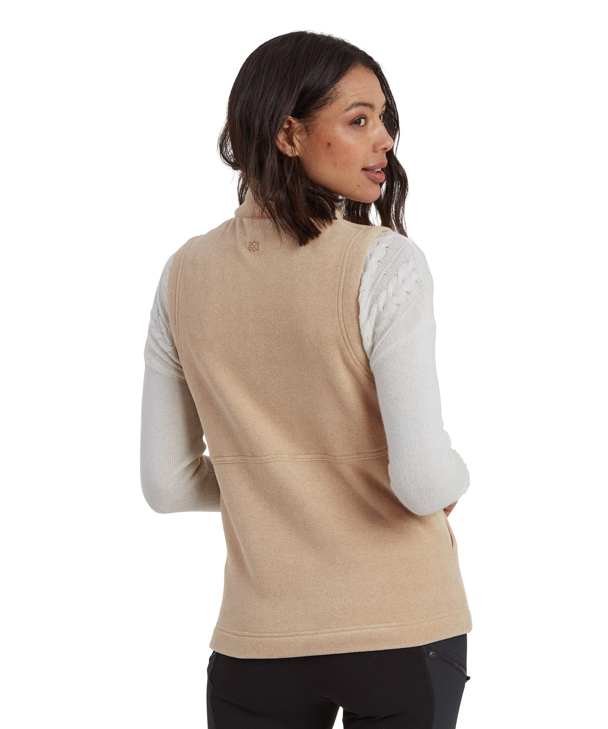 Tthe back view of the Sherpa Adventure Gear Rolpa Eco Vest in Beige, showing its simple, clean lines and the subtle logo detailing at the nape of the neck. The straight-cut hemline ensures a flattering fit over the hips.