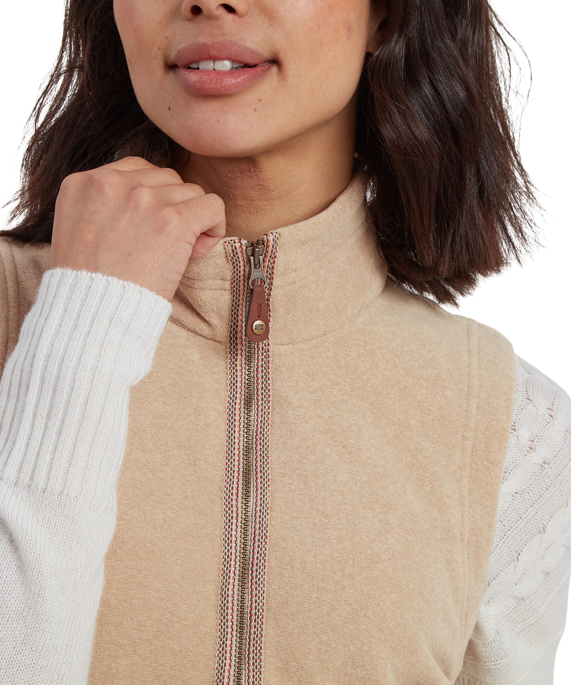 A detailed view of the Sherpa Adventure Gear Rolpa Eco Vest in Beige’s front pocket, showing its practicality for keeping hands warm or storing small essentials. The soft fleece texture and precise stitching are highlighted, demonstrating the garment's quality craftsmanship.