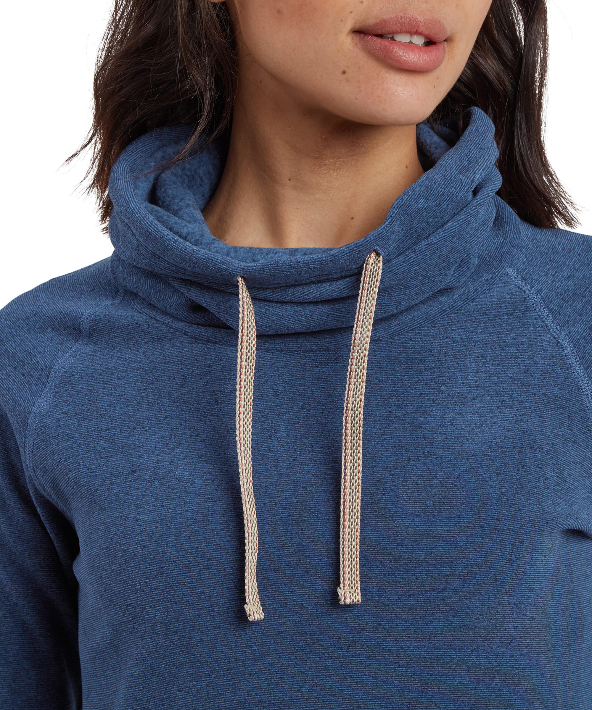 A close-up shot of the Sherpa Adventure Gear Rolpa Eco Pullover in Blue's high cowl neck, which is gathered and features two beige drawstrings. The texture of the fabric is visible, with a subtle heathered effect in the blue color. The woman’s lips and chin are partially visible at the top of the frame.