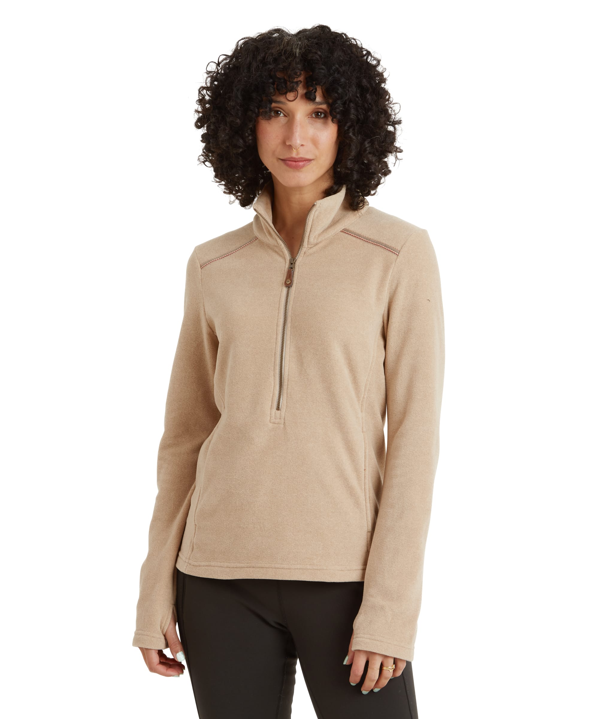 A woman is wearing a Sherpa Adventure Gear Rolpa Eco Pullover Zip in Beige with a quarter-zip closure, standing against a neutral background. The pullover features a soft, fleece-like texture with stitching details on the shoulders. She has dark curly hair and is looking straight at the camera with a calm expression.