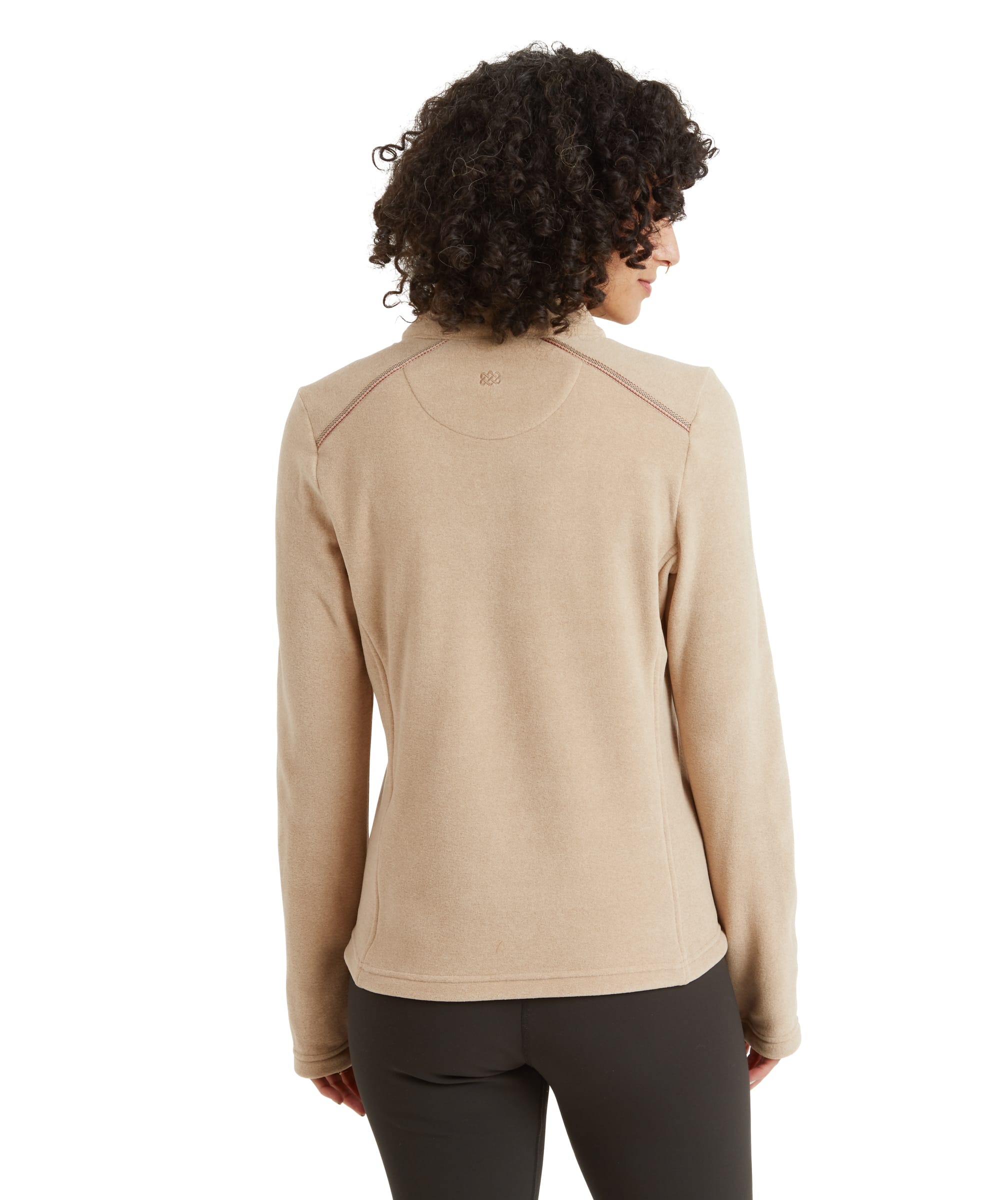 The back of the Sherpa Adventure Gear Rolpa Eco Pullover Zip in Beige is shown, highlighting a subtle circular stitching detail across the upper back. The hemline of the pullover falls slightly lower, providing moderate coverage over black leggings.