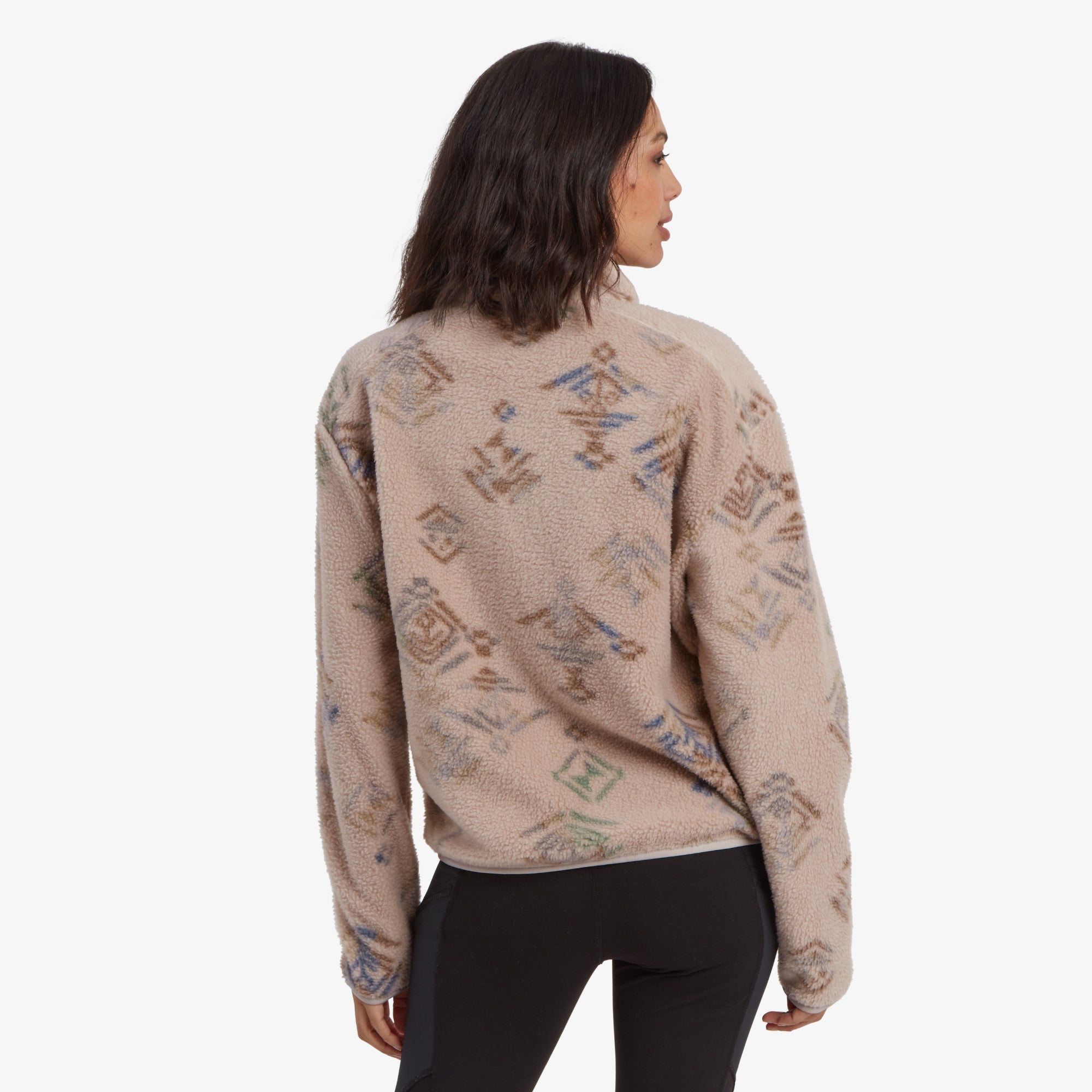 A back view of the Sherpa Adventure Gear Uddesya Eco Jacket in Light Brown, displaying the overall pattern of colorful geometric shapes. The jacket’s relaxed fit and fleece texture are evident, along with its high collar design.