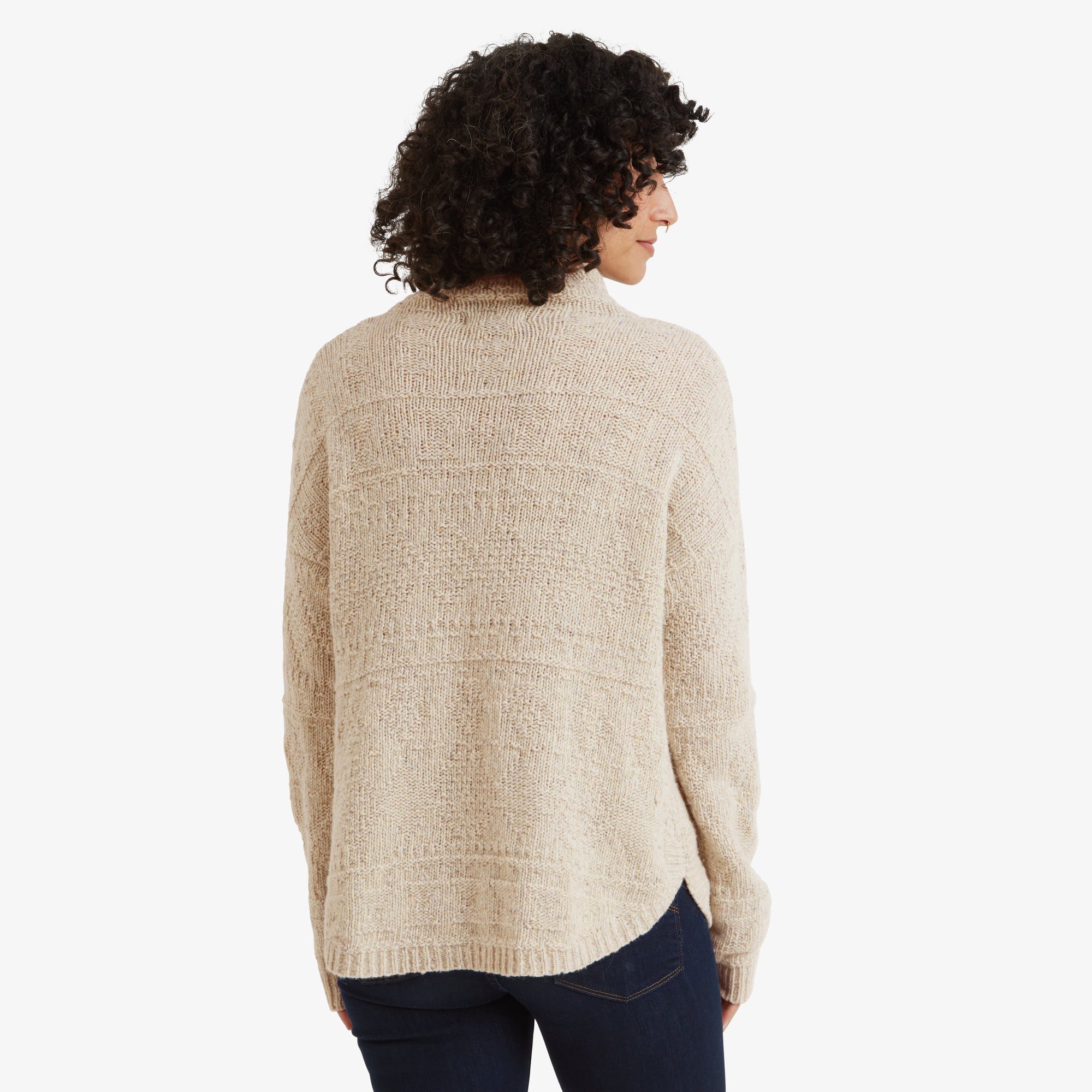 The back of the Sherpa Adventure Gear Yuden Sweater in White displays its seamless knit pattern and relaxed fit. The longer hem at the back provides added coverage and a flattering shape.