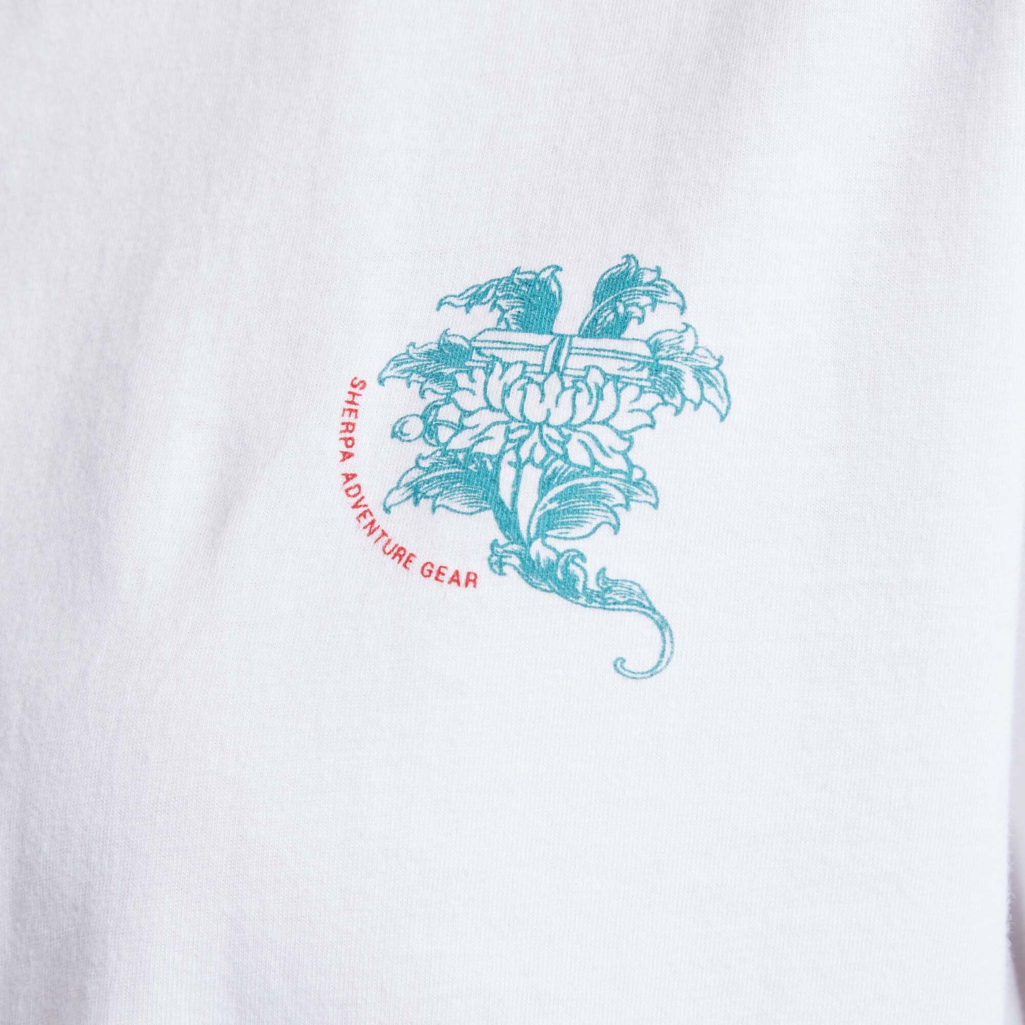 A close up of the front logo detail on the Sherpa Adventure Gear Deity T-Shirt in White